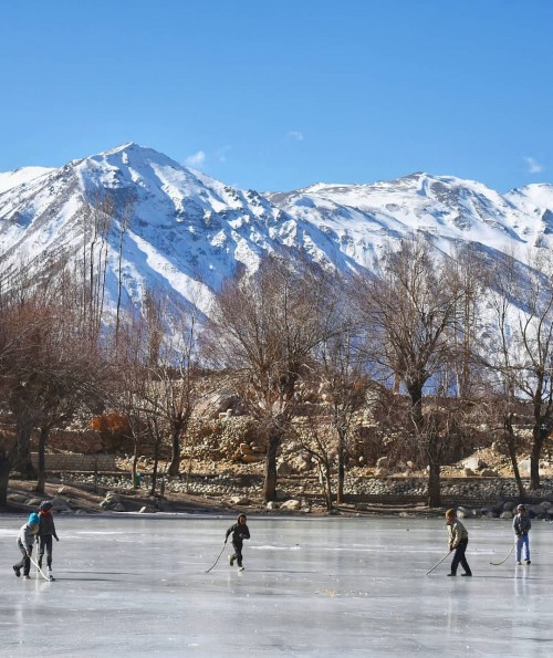 Nako, Himachal Pradesh - little kids playing their kind of ice hockey without any fear of drowning down.